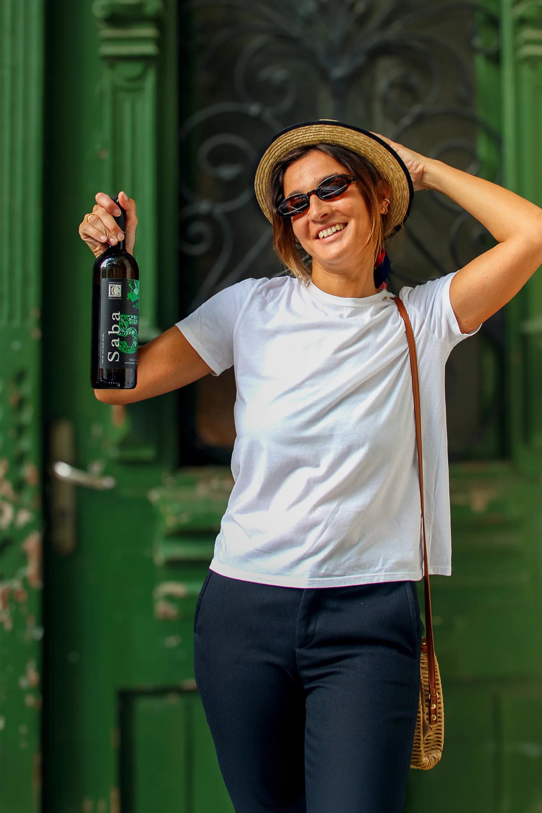 Holding a bottle of Lanchava Collection wine